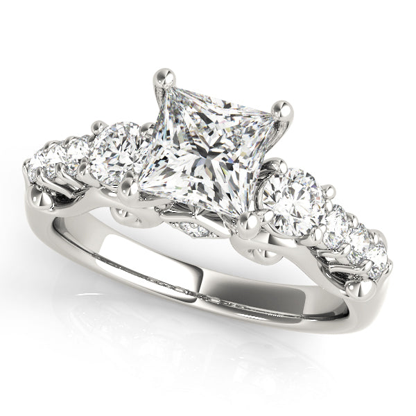 Diamond ring with a central princess-cut diamond and smaller round diamonds on a white background