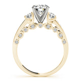 Gold ring with a diamond and smaller gemstones on a white background