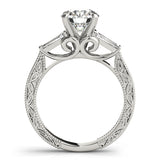 Silver ring with intricate design and a central diamond on a white background