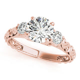 Rose gold ring with three diamonds on a white background