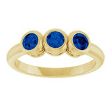 Round Lab-Grown Blue Sapphire Three Stone Ring in Yellow Gold