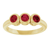 Round Lab-Grown Ruby Three Stone Ring in Yellow Gold