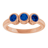 Round Lab-Grown Blue Sapphire Three Stone Ring in Rose Gold