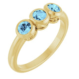 Round Aquamarine Three Stone Ring in Yellow Gold