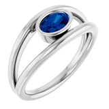 Oval Blue Sapphire Negative Space Ring in Gold and Platinum