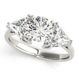 Diamond ring with two triangle-cut diamonds and a round center stone on a white background