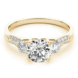 Gold ring with a large diamond and smaller diamonds on the sides against a white background