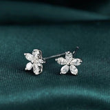 Boucles d'oreilles pendantes Aazuo en or blanc 18 carats, serties de véritables diamants en forme de piriforme et ornées de cinq fleurs féeriques. Idéales pour un mariage, des fiançailles ou une soirée. Au750