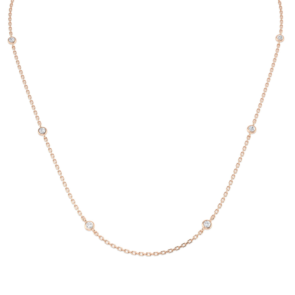 Rose gold necklace with small diamonds on a white background