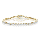 A yellow gold tennis bracelet with a diamond inset in a rub-over setting.