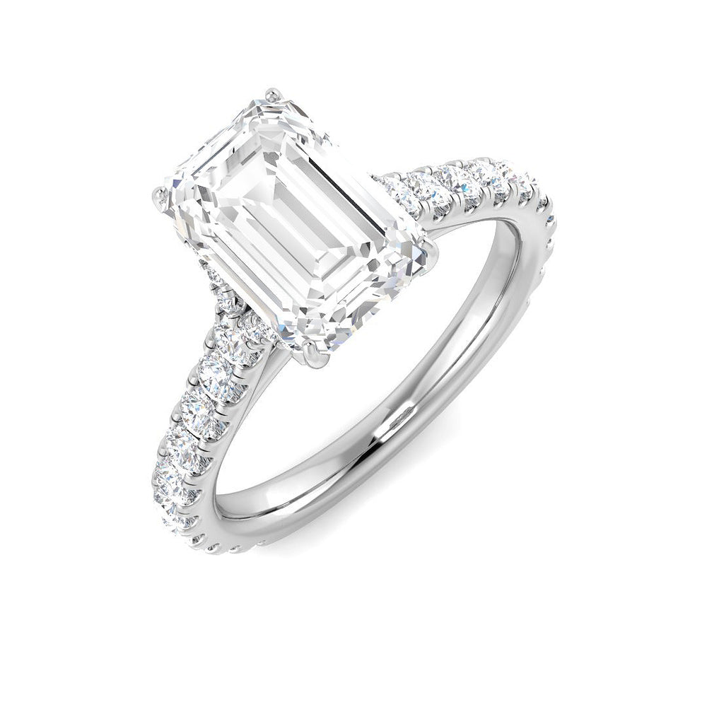 Emerald cut diamond engagement ring in white gold with prong set centre and diamond set shoulders