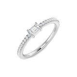 Emerald cut diamond solitaire engagement ring with pavé band in white gold, featuring a natural diamond