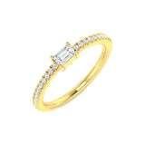 Gold ring with emerald-cut diamond and smaller diamonds on a white background