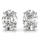 A pair of oval-cut lab-grown diamond stud earrings with a 4-prong setting in a white gold or platinum color, with a clear and vibrant appearance.