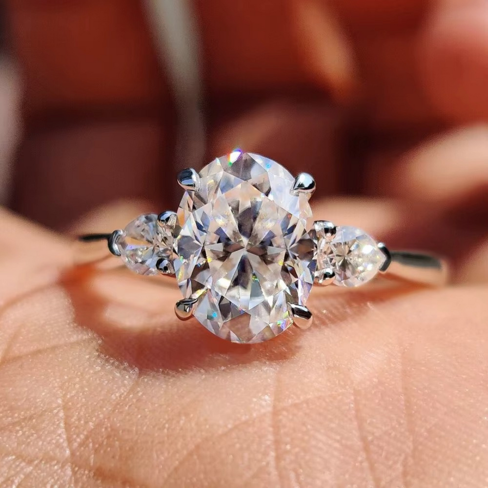 Oval Diamond and Pear Diamond Three Stone Engagement Ring