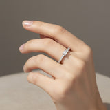 Emerald diamond side stone engagement ring with pavé