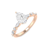 Rose gold ring with a pear-shaped diamond on a white background