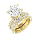 Gold ring with a large diamond and smaller diamonds on a white background
