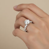 Round diamond solitaire ring with claw-set diamond shoulders