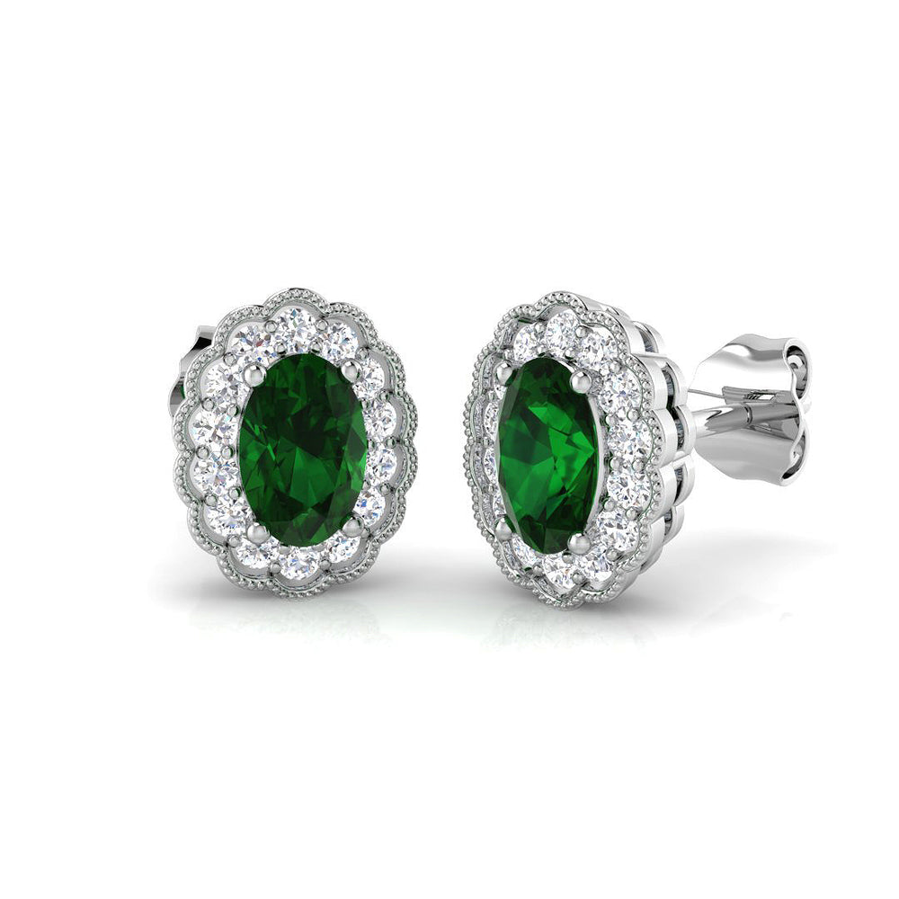 Oval cut emerald halo stud earrings with gemstone cluster setting