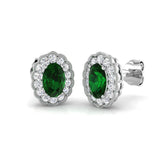 Oval cut emerald halo stud earrings with gemstone cluster setting