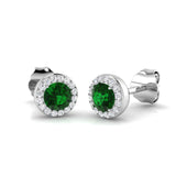 Pair of silver earrings with green gemstones on a white background