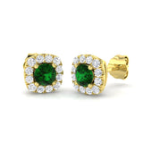 Round emerald stud earrings featuring pave set diamond halo