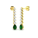Emerald pear drop earrings featuring round prong set diamond accents