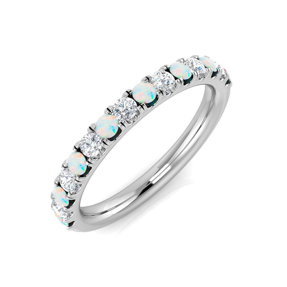 Silver ring with opal and diamond stones on a white background