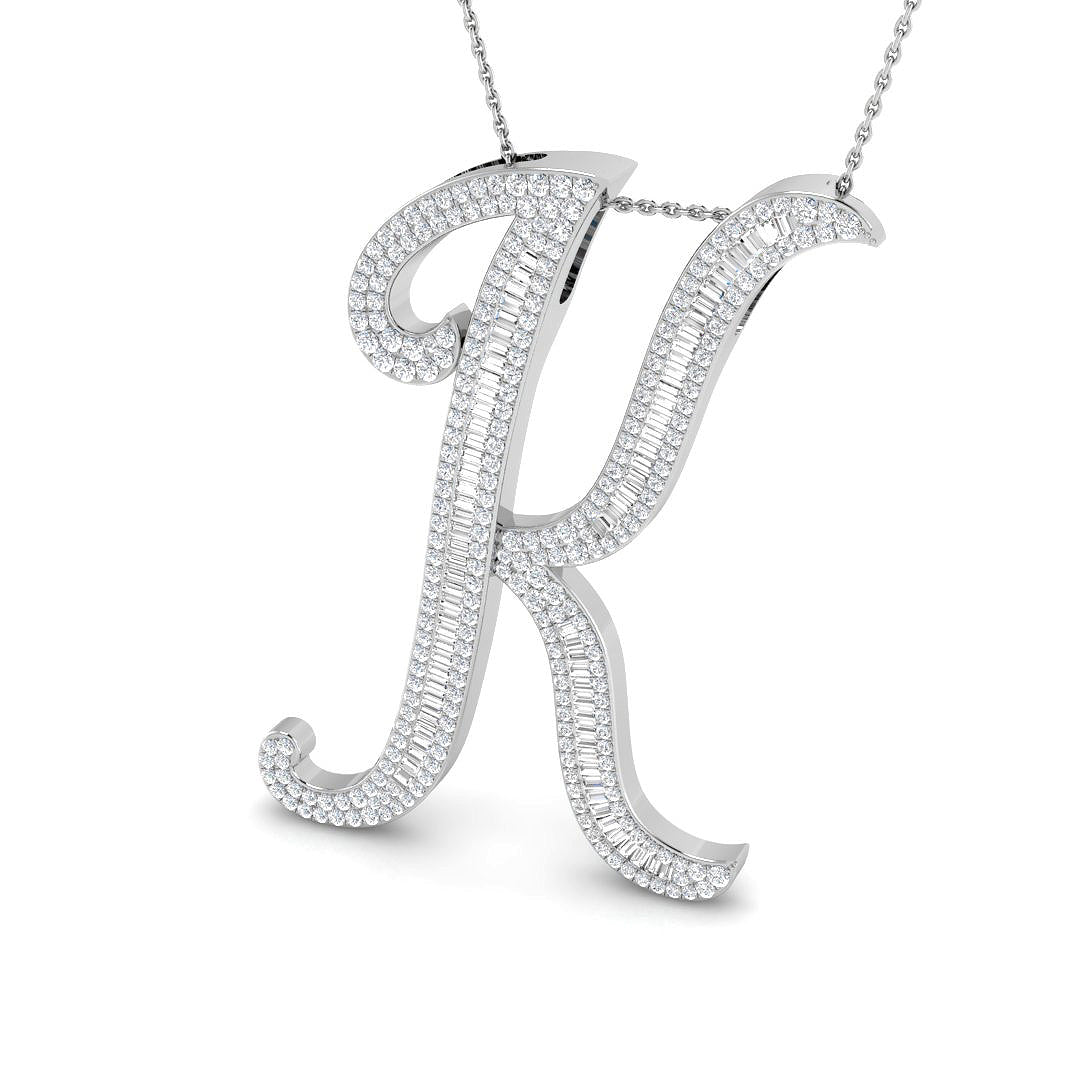 Gold initial pendant with baguette and round cut diamonds.