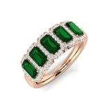 Emerald Five Stone Ring with diamond pave halo band showcasing vibrant emerald cut gemstones.