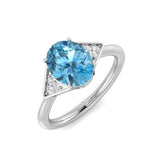 Oval Cut Blue Topaz Ring with Round Side Stones in White Gold