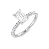 Diamond ring with emerald-cut center stone on a white background