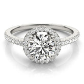 Close-up of a DE colour, VS clarity round lab-grown diamond solitaire ring with sparkling side diamonds.