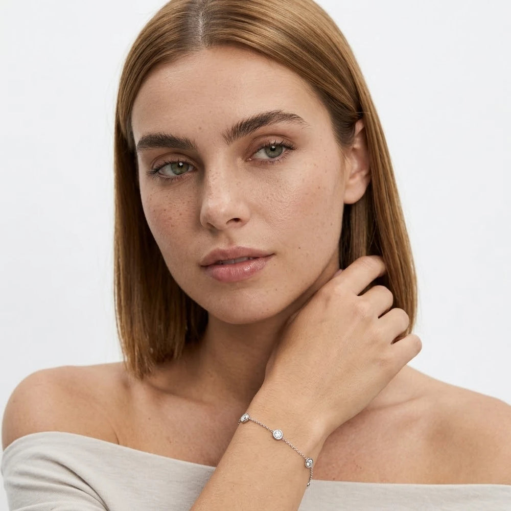 FineDiam round diamond bezel set bracelet with a fine white metal chain and evenly spaced circular settings.
