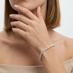 FineDiam diamond tennis bracelet with closely set round stones and a polished white metal finish.