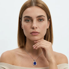FineDiam blue rectangular gemstone halo pendant featuring a diamond border and delicate white metal chain.