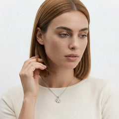 FineDiam diamond flower pendant featuring closely arranged round stones and a polished white metal chain.