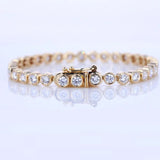 Gold bracelet with diamonds on a light gray background