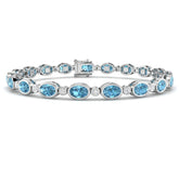 Bezel Set Oval Cut Blue Topaz and Round Diamond Tennis Bracelet in 9K White Gold