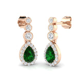 Green emerald teardrop earrings in rose gold featuring diamond halo and push back fitting