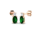 Luxury oval emerald diamond stud earrings featuring emerald gemstones