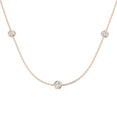 Rose gold necklace with small round diamonds on a white background