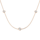 Rose gold necklace with small round diamonds on a white background