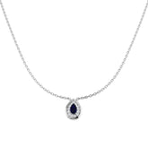 Teardrop-shaped pendant with a blue gemstone on a silver chain against a white background