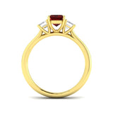 Ruby Three Stone Ring featuring emerald cut ruby centerpiece and diamond side stones in a gold setting.