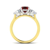 Ruby Three Stone Ring showcasing an oval cut ruby center and diamond side stones, set in gold.