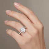 Diamond ring on a hand against a neutral background