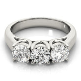 Top-down view of a classic three-stone lab-grown diamond engagement ring featuring three round brilliant diamonds in yellow gold.