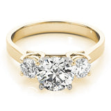 Gold ring with three diamonds on a white background